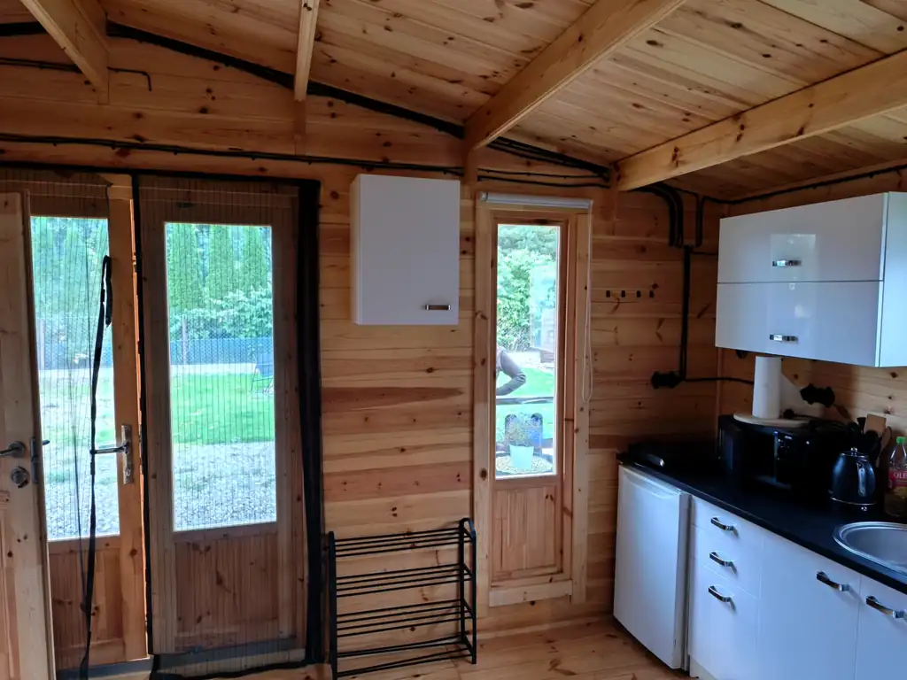 Double glazed doors from the living room of cottage no. 3 to the terrace, with the kitchenette on the right